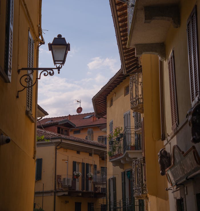 Explore a picturesque Italian alley with charming historic architecture and a tranquil summer ambiance.